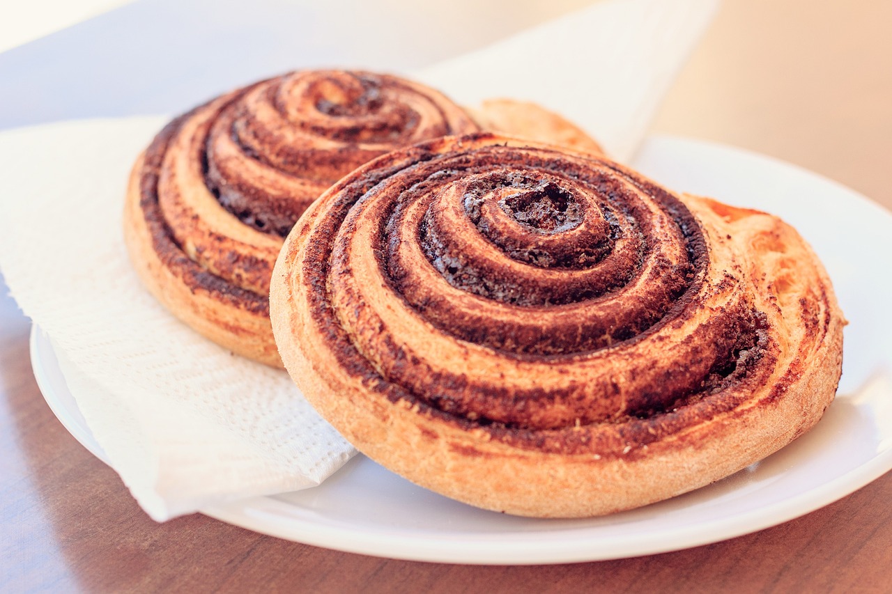 Two cinnamon swirl buns on a plate
